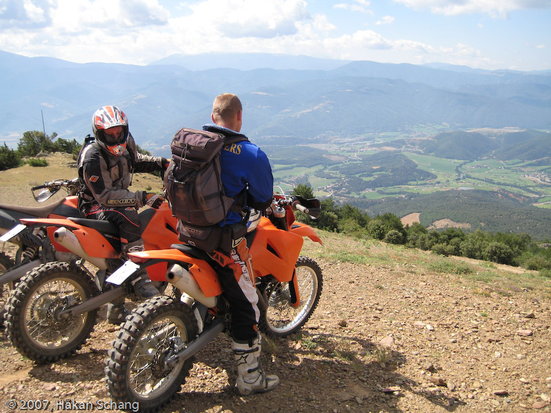 Below the grassy slope lies one of the top roads during the tour; a beautiful curvy dirt road just lose enough to make super-moto like slides into every corner. Great fun!